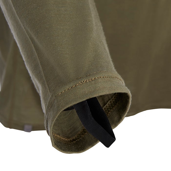 Close-up of olive green long-sleeve shirt detail showing a black elastic band and subtle stitching on the cuff