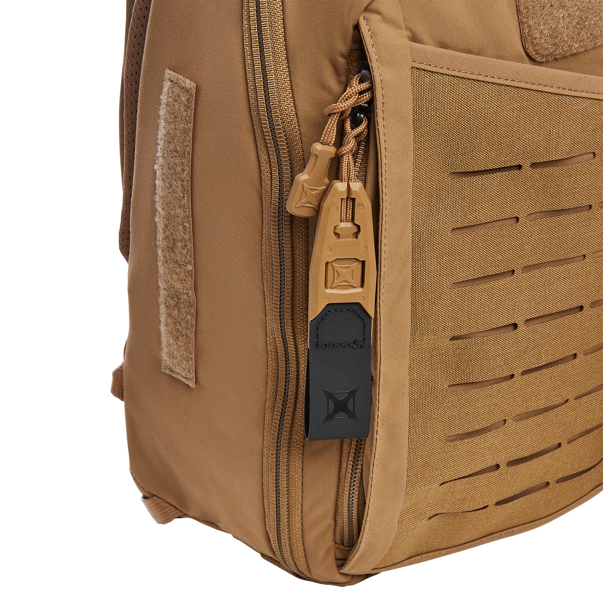 Close-up of a tan tactical backpack detail showing a zippered compartment with tan paracord pulls and a black branded tab a fuzzy velcro patch and a laser-cut MOLLE panel