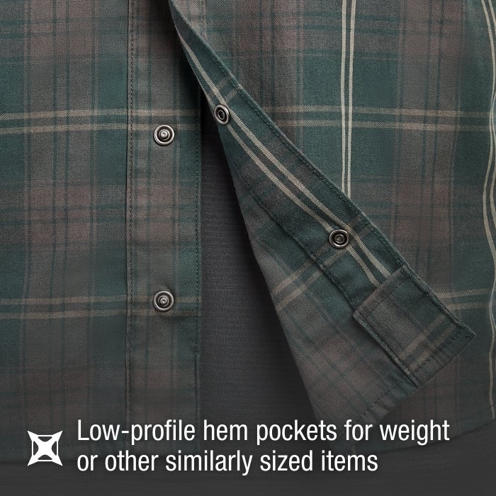 Close-up of a green and brown plaid flannel shirt showcasing low-profile hem pockets, silver buttons, and a soft gray interior lining