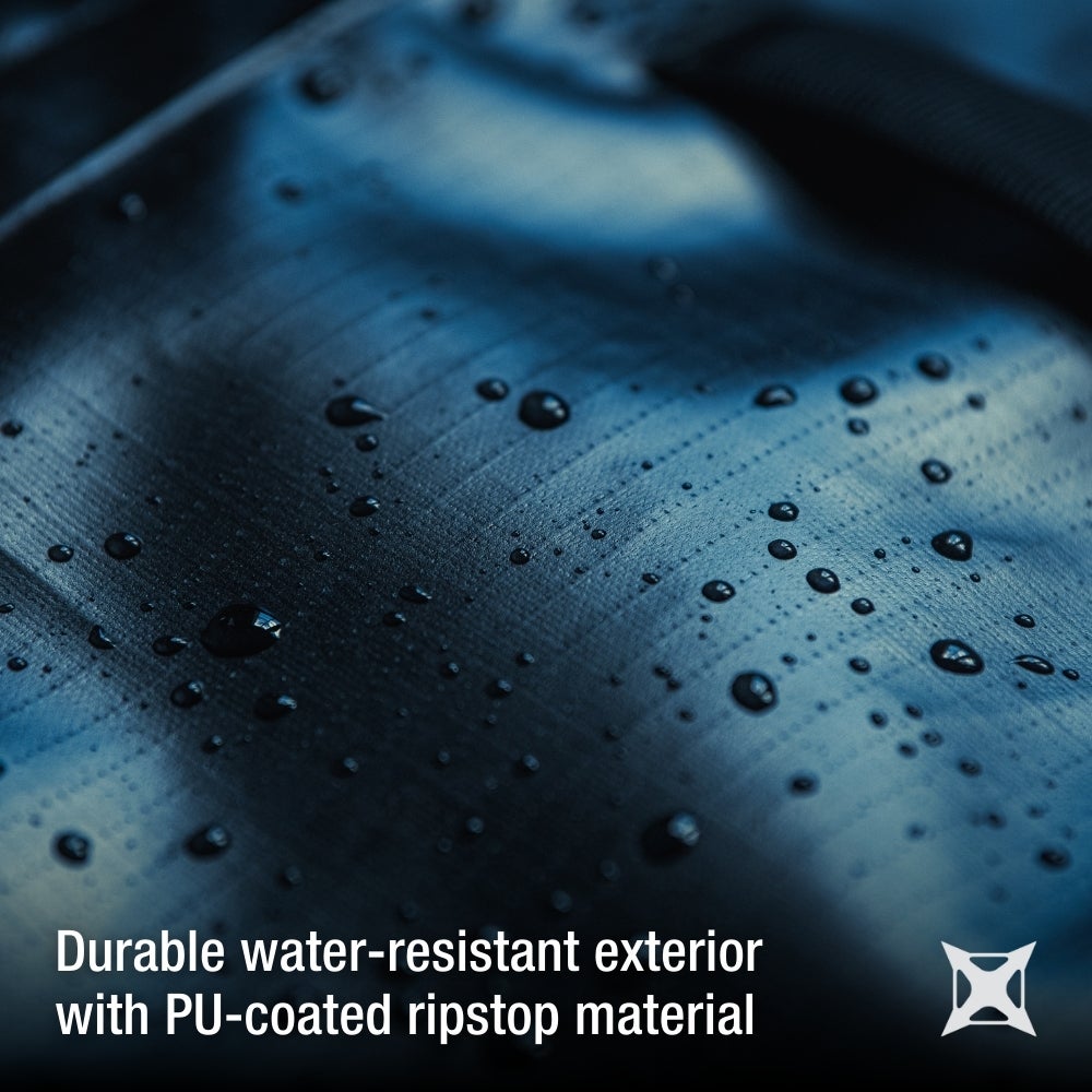 Close-up photograph showing a dark blue PU-coated ripstop fabric with water droplets showcasing its water-resistant texture and deep color variations.