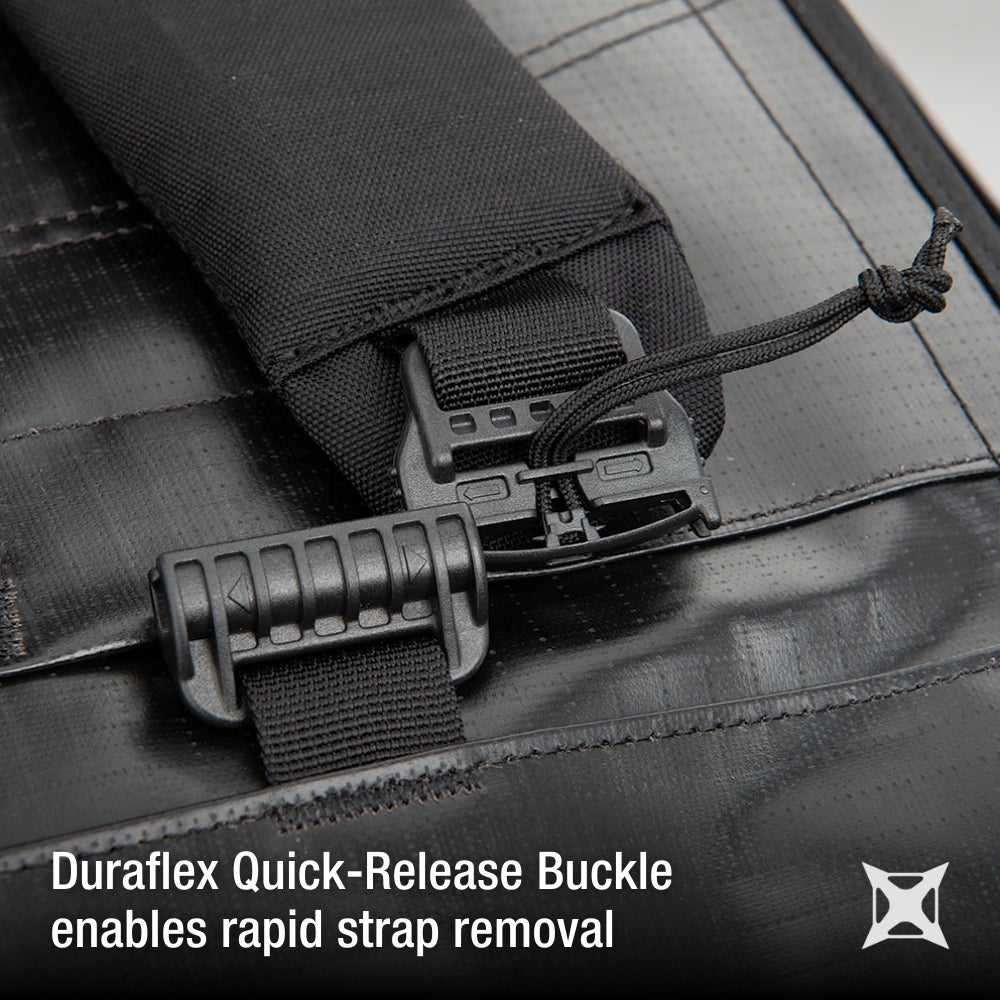 Product photography detail shot of a black Duraflex quick-release buckle on a black nylon strap showing textured fabric and a tied cord with multiple release mechanisms