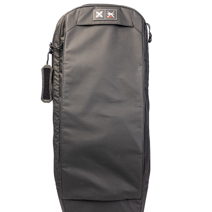 Product photography of a black Dakine surfboard bag featuring a zippered side pocket a padded handle and a logo patch