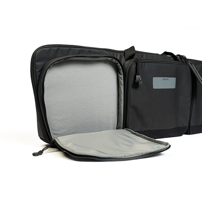 Product shot of a black Xvert gun case showing multiple zippered compartments soft gray lining and a branded label