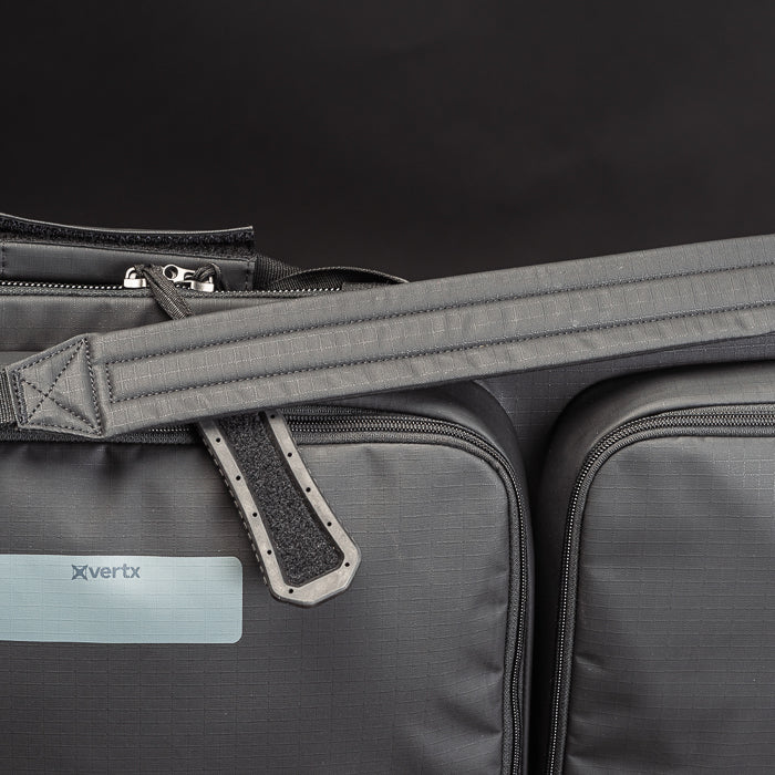 Product shot of a Vertx dark gray tactical bag featuring a padded shoulder strap, textured fabric, and a unique molded plastic strap adjuster