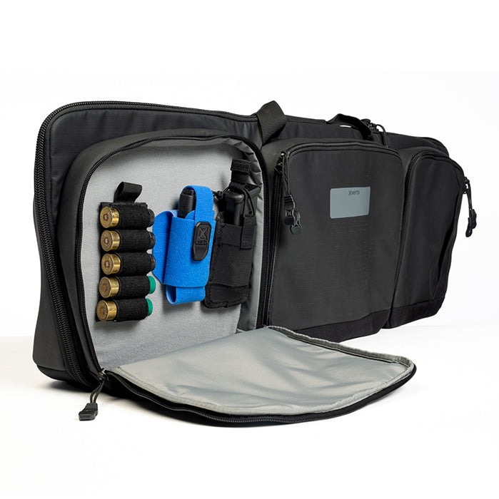 Product shot of a Xert tactical range bag showing multiple compartments a bright blue pistol wrap gray interior and shell holders