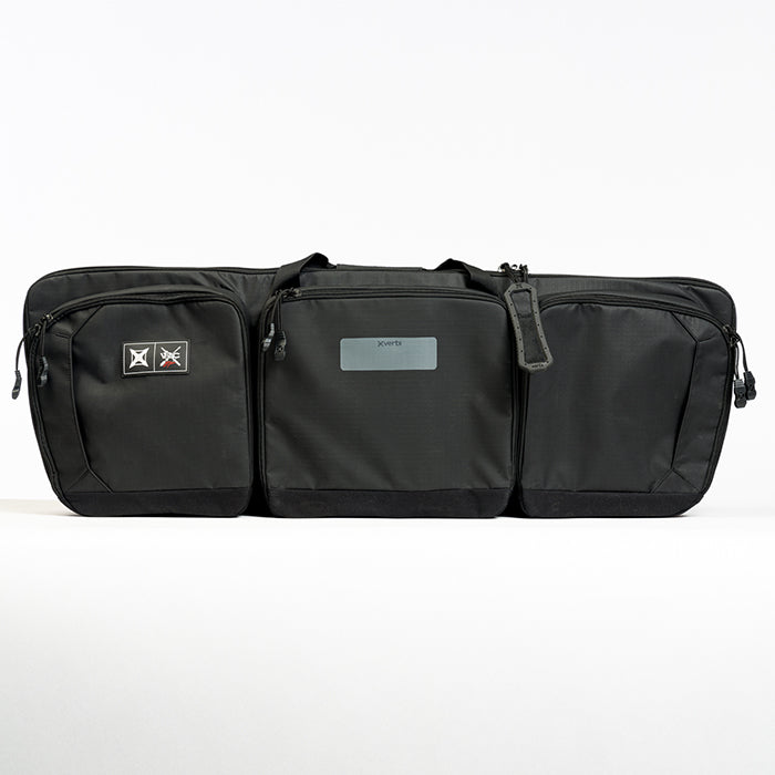 Product shot of a black XVert rifle case featuring multiple zippered compartments and a gray logo tag showcasing robust construction and tactical design
