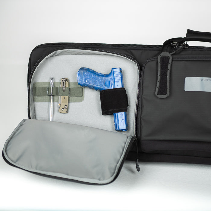 Product Photography showing a black X Verde gun case with a blue Glock pistol a tactical pen and a folding knife inside