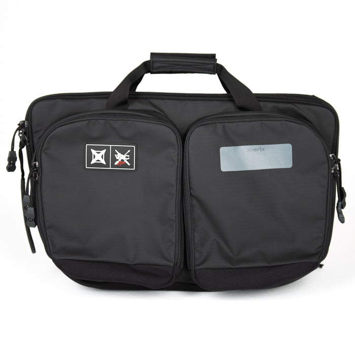 Product photography of a black Xvertx carrying case featuring two zippered compartments a top handle and a logo patch with red and white details.