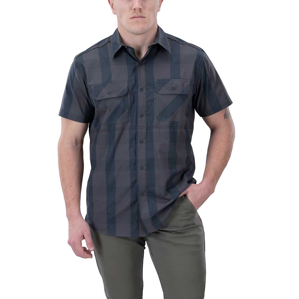 Product shot of a man modeling a dark gray and black vertically striped short-sleeved button-down shirt with two chest pockets and olive green pants against a white background