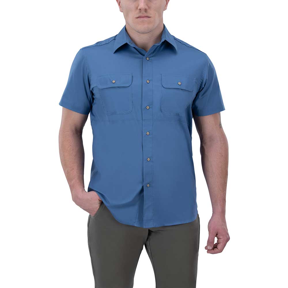 Product shot of a man wearing a blue short-sleeved button-down shirt with two chest pockets and olive green pants against a white background
