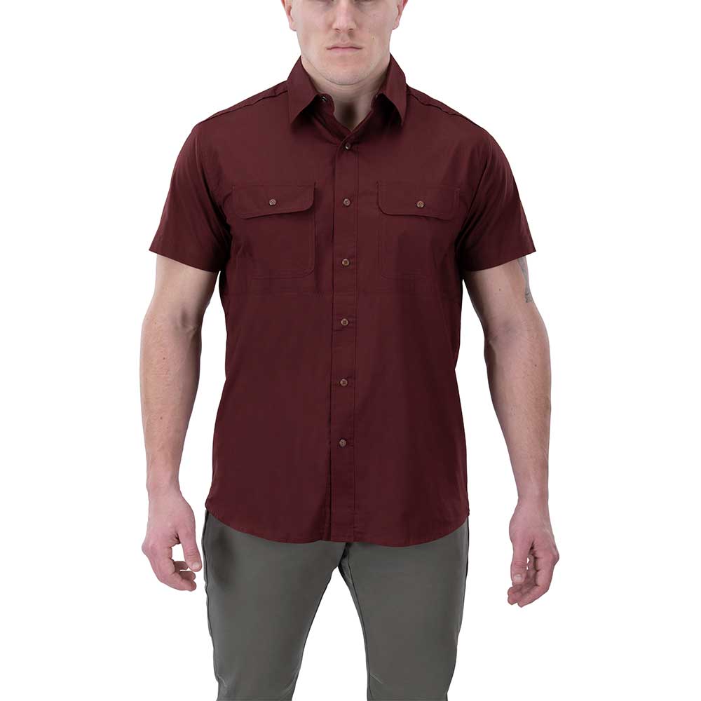 Product shot of a maroon short-sleeved button-down shirt with two chest pockets and copper buttons on a male model against a white background