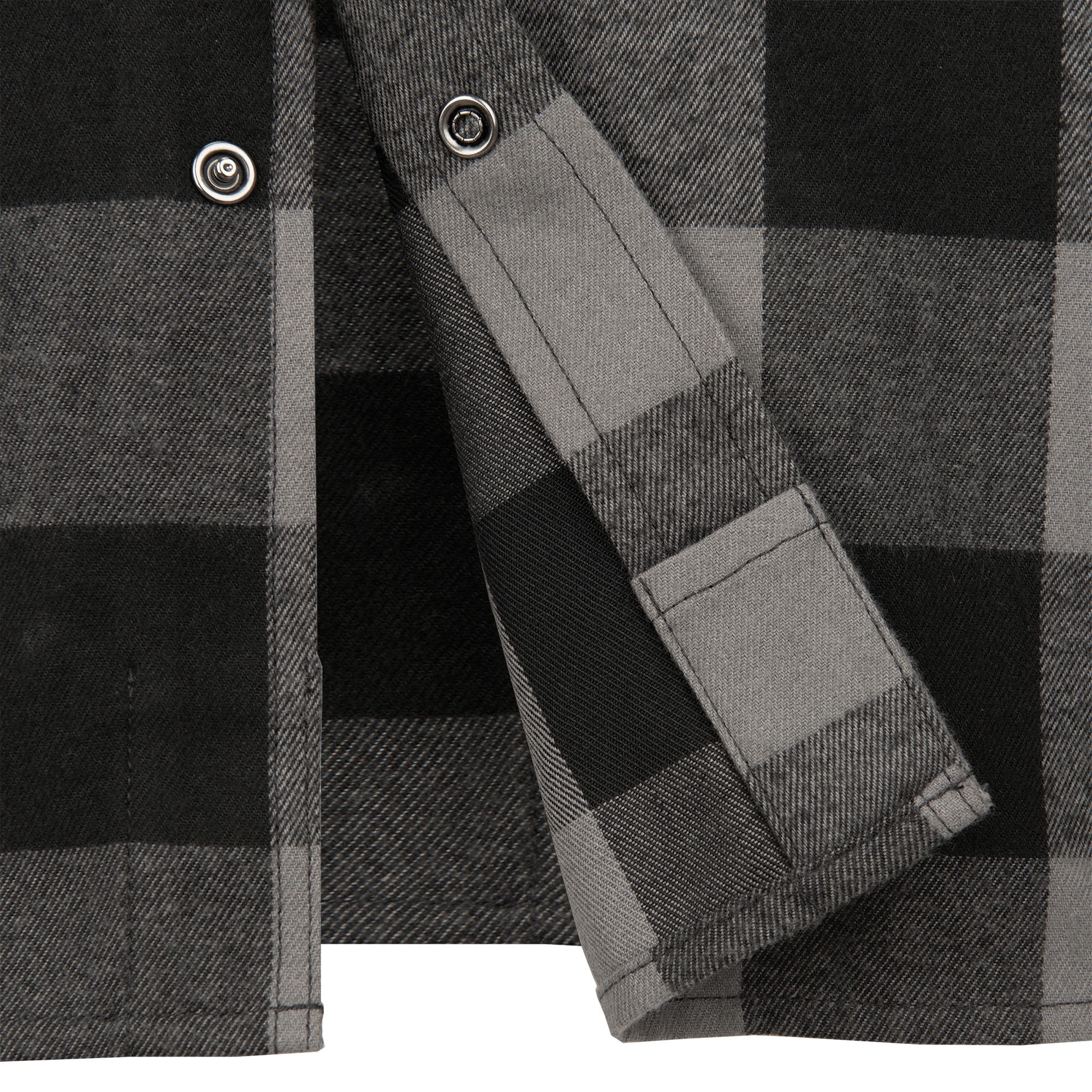 Close-up of a gray and black plaid shirt featuring metal buttons a visible pocket and subtle textural details