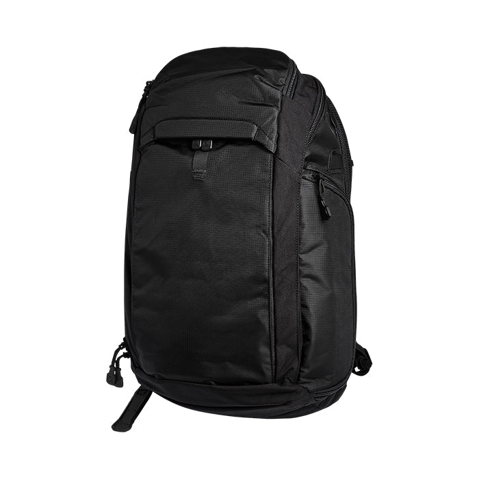 Product shot of a black backpack featuring multiple zippered compartments and compression straps against a white background