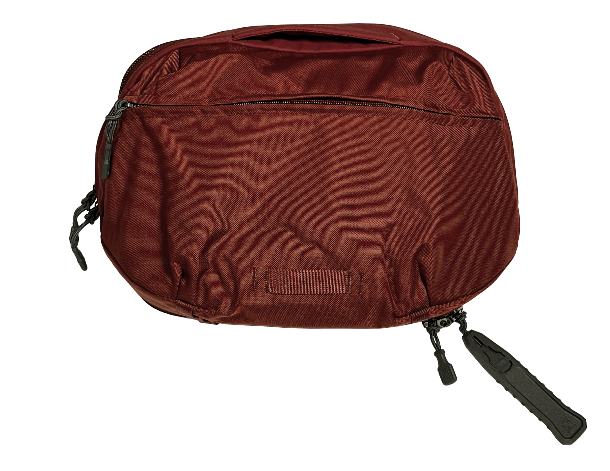 Photograph of a deep red, Peak Design Everyday Sling bag featuring a textured fabric, gray zippers, and a dark gray, zipper pull with a unique design.