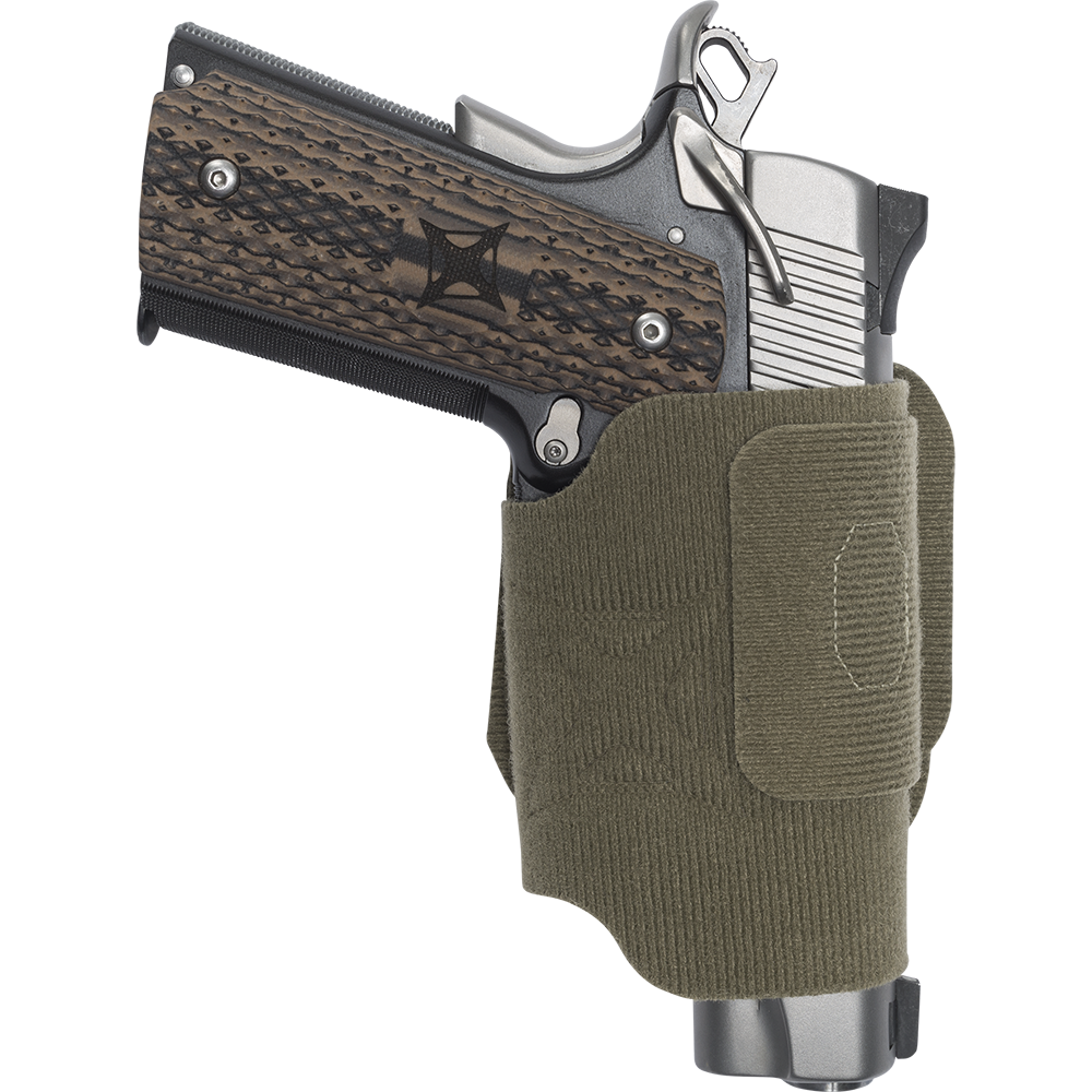 Product shot of a Colt 1911 pistol in an olive drab green fabric holster featuring a dark wood grip with a stylized cross emblem and silver accents