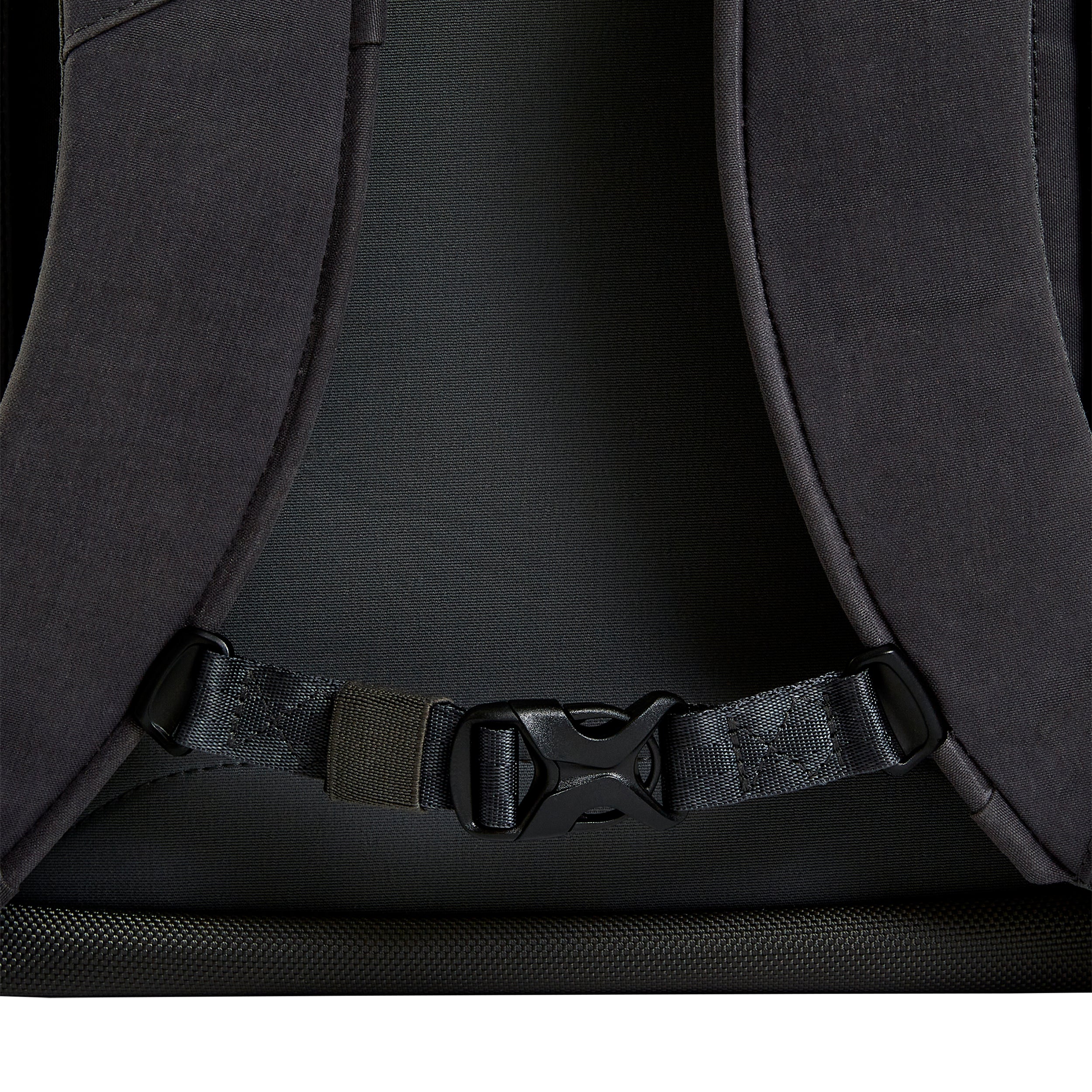Close-up product shot of a dark gray backpack featuring adjustable straps, a textured bottom panel, and a black plastic clasp