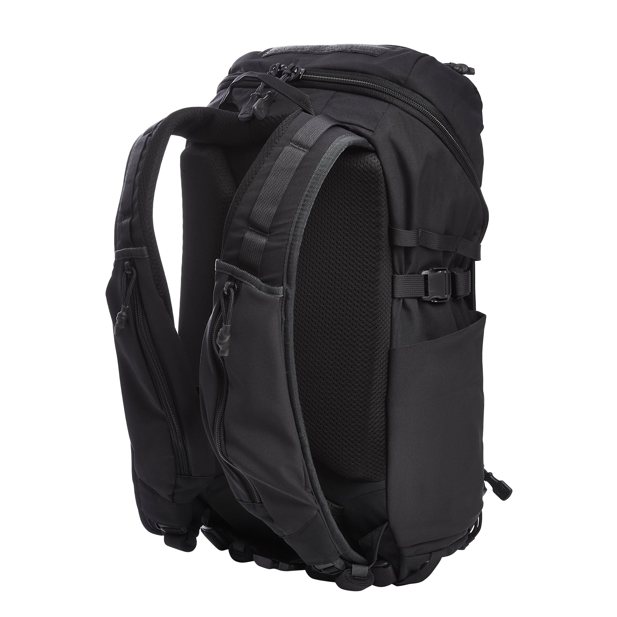 Photograph of a black tactical backpack featuring padded shoulder straps, a breathable mesh back panel, and multiple durable zippered compartments with compression buckles