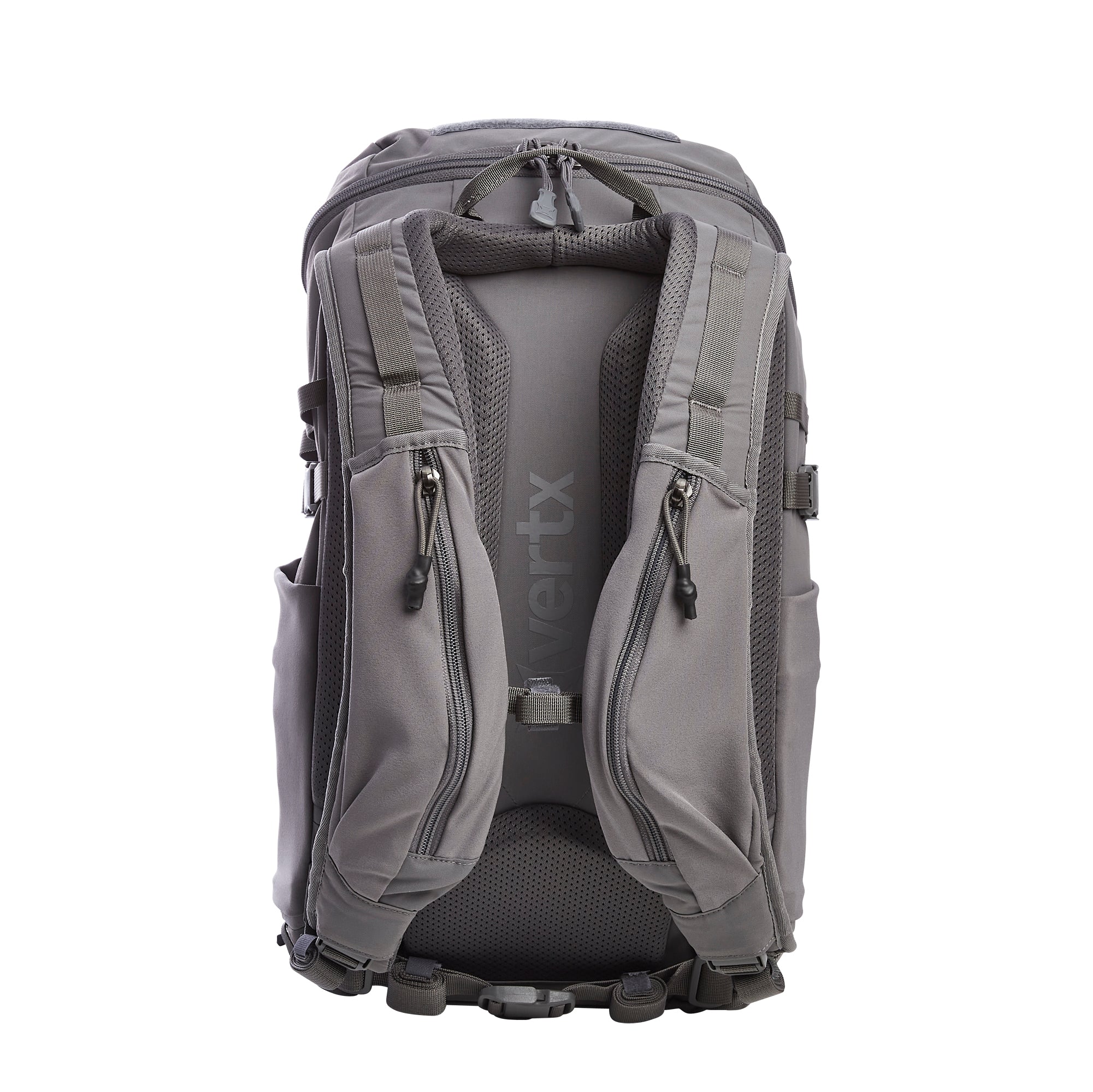 Product photo of a Vertx grey tactical backpack on a white background showcasing the back panel with an embossed Vertx logo, padded mesh shoulder straps, and two zippered quick-access pockets with pull tabs