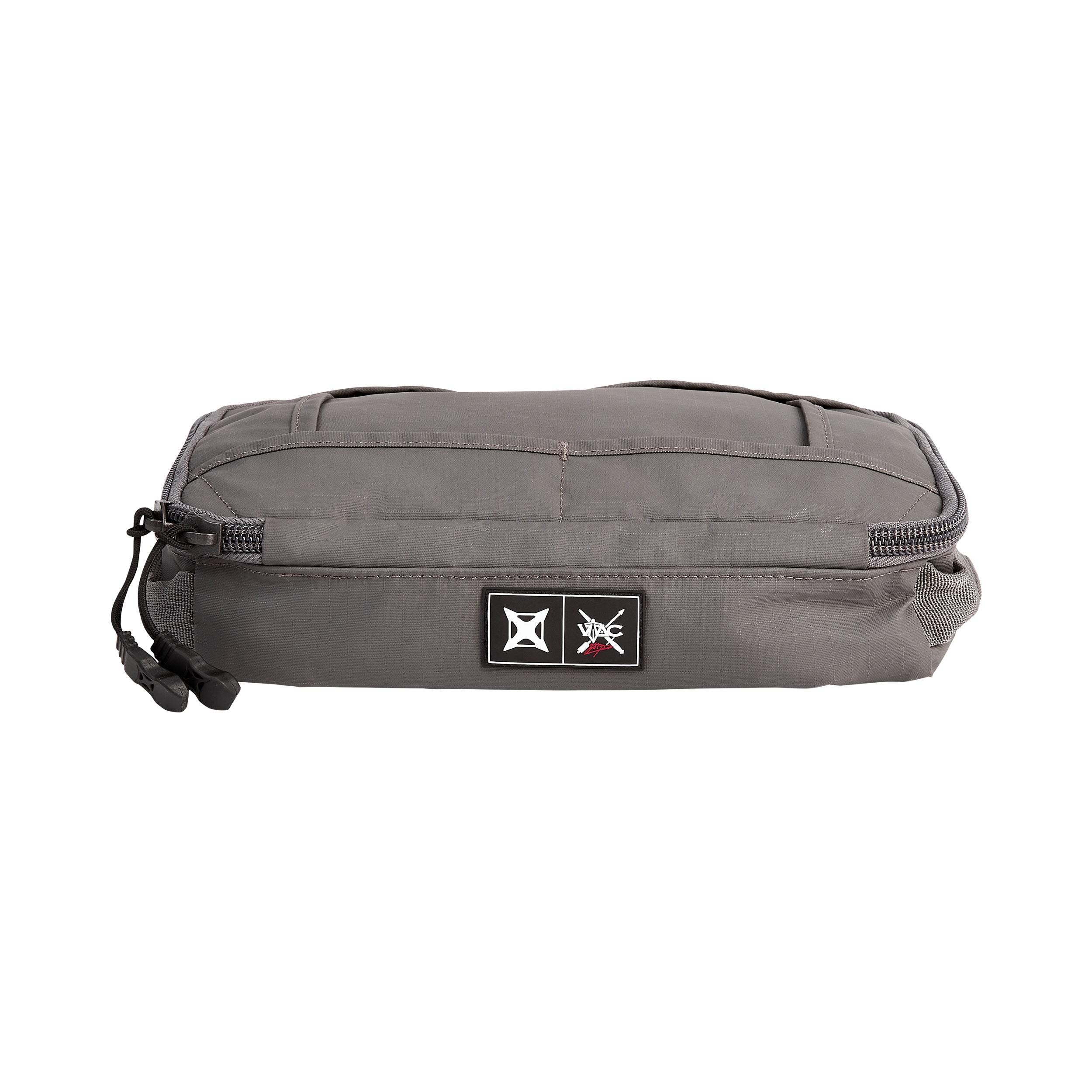 Product shot of a gray VAC travel bag featuring black zippers, a unique logo patch, and subtle contrasting stitching