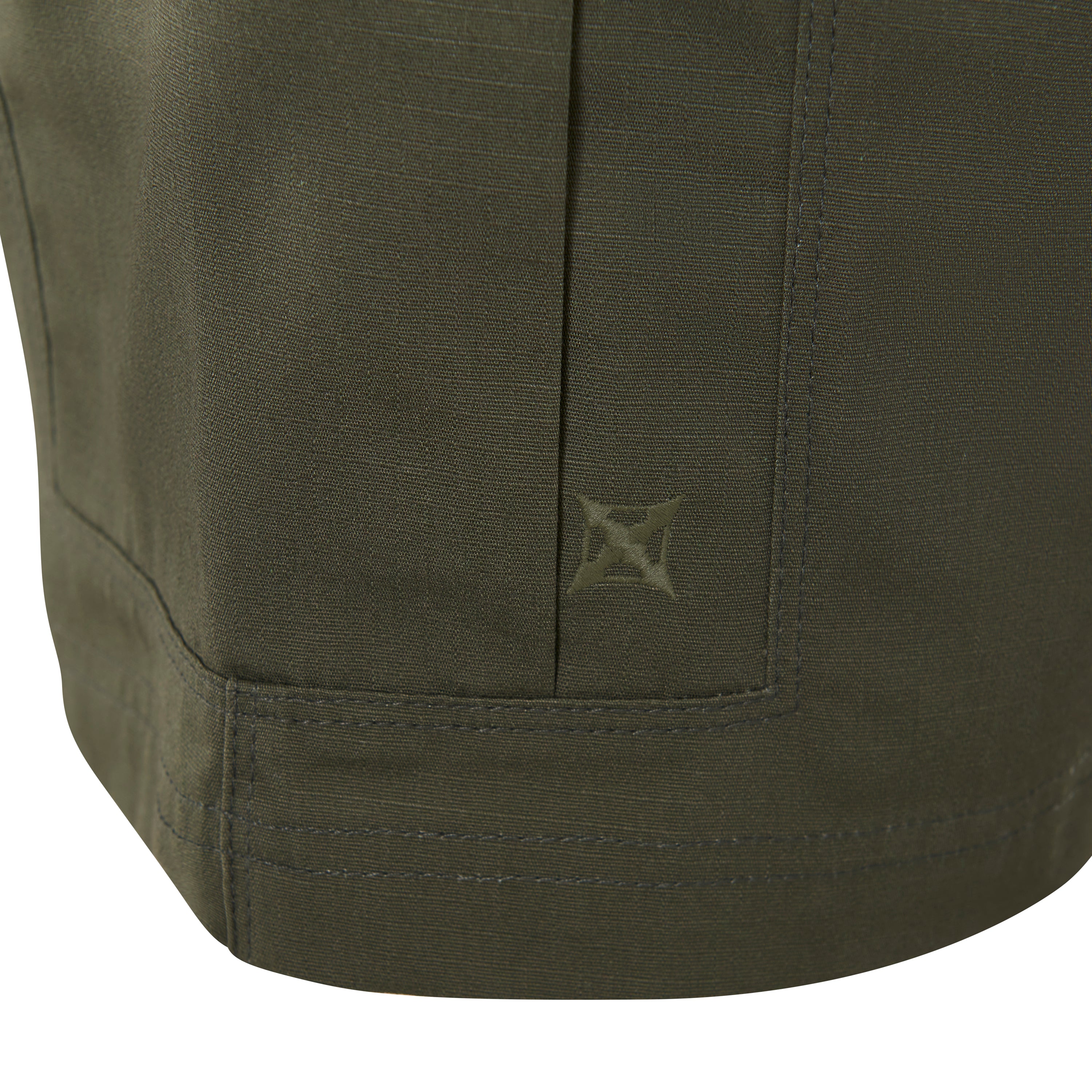 Close-up of olive green fabric showing detailed stitching, a subtle embroidered logo, and a textured surface