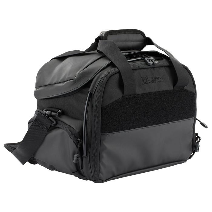 Product shot of a Vertex black tactical duffel bag featuring a padded top handle MOLLE webbing and a durable water-resistant exterior