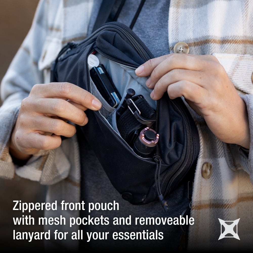 Product photography showing a person holding open a black zippered fanny pack revealing a grey mesh pocket and items like a silver wallet a carabiner and a rose gold flashlight
