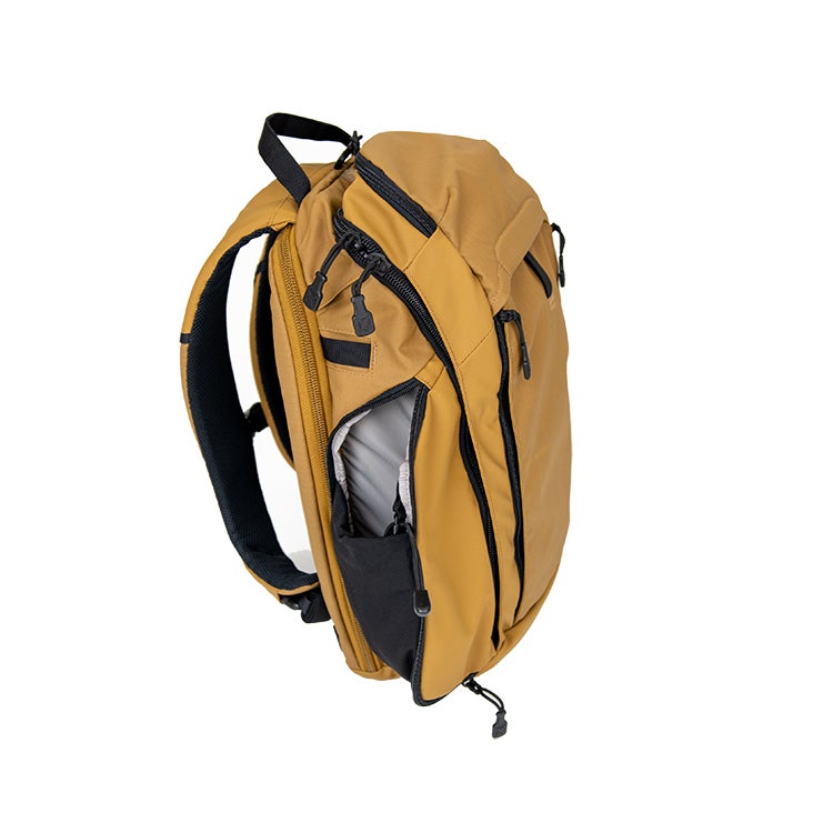Product shot of a mustard yellow and black backpack showing multiple zippered compartments and a padded laptop sleeve.