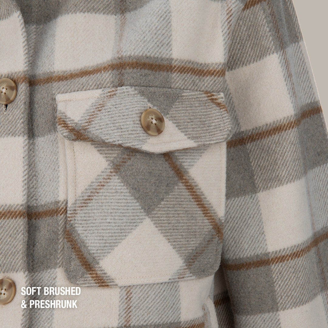 Close-up of a soft brushed and preshrunk gray and beige plaid shirt featuring a noticeable chest pocket and large brown and white buttons