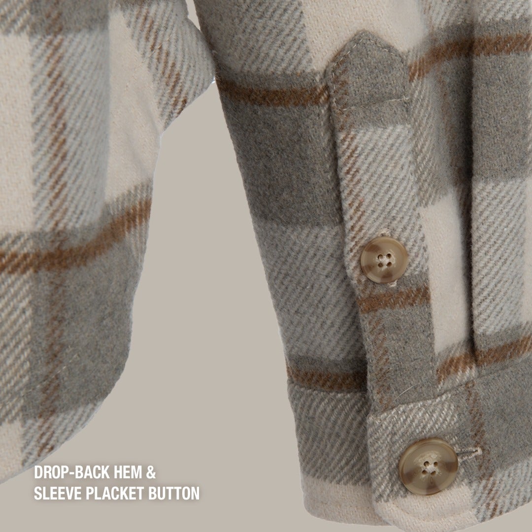 Close-up of a wool shirt sleeve showcasing a drop-back hem, sleeve placket with buttons, and a grey, beige, and brown plaid pattern
