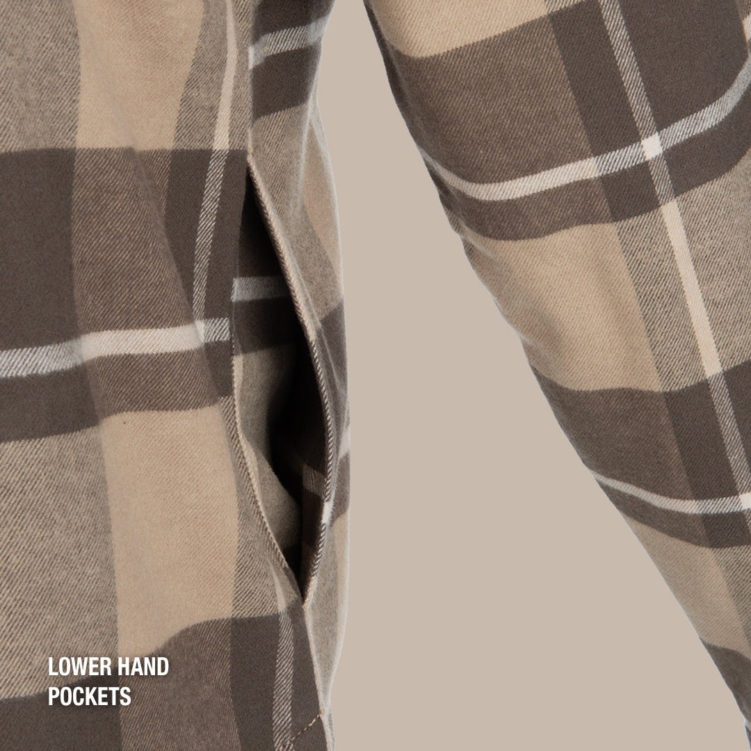 Close-up of a beige and brown plaid flannel shirt showcasing lower hand pockets with visible stitching and a subtle texture
