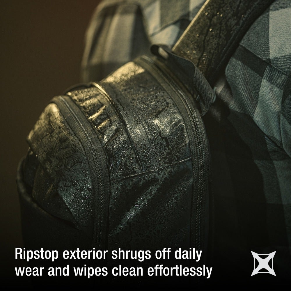 Product shot of a black ripstop backpack showing water droplets zippers and textured fabric