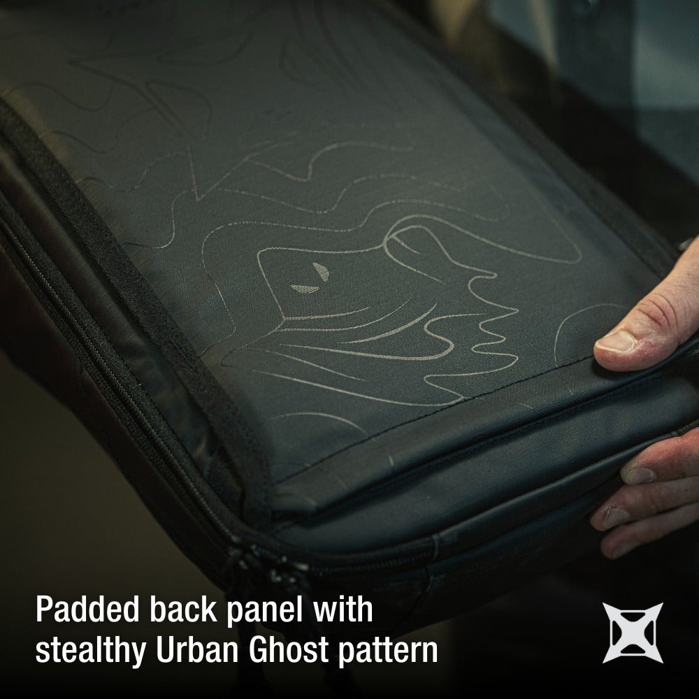 Close-up product shot of a black padded backpack featuring a subtle Urban Ghost pattern with embossed lines, dark gray detailing and a subtle zip detail