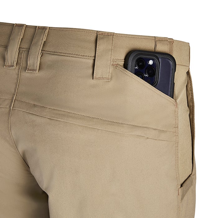 Product shot showing beige tactical pants with a smartphone in the back pocket featuring reinforced stitching and a secure fit