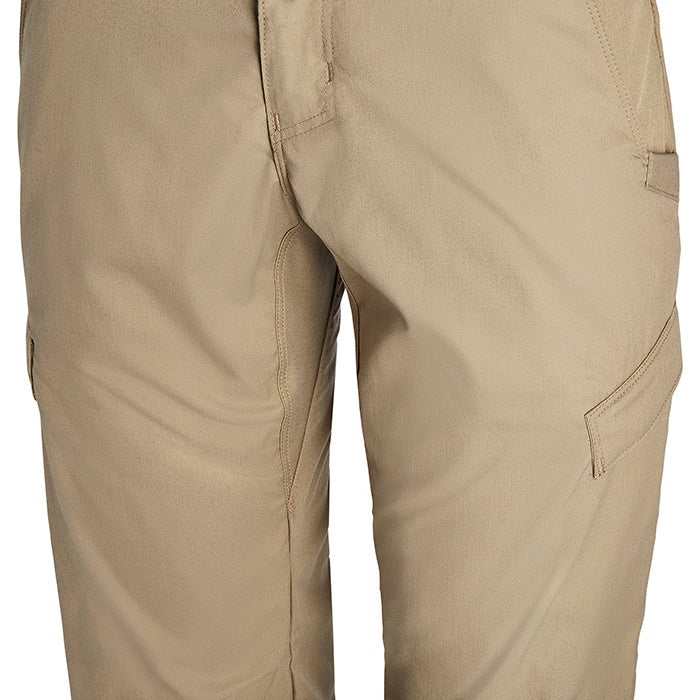 Close-up product shot of tan cargo pants showing a button fly, reinforced stitching, and multiple pockets