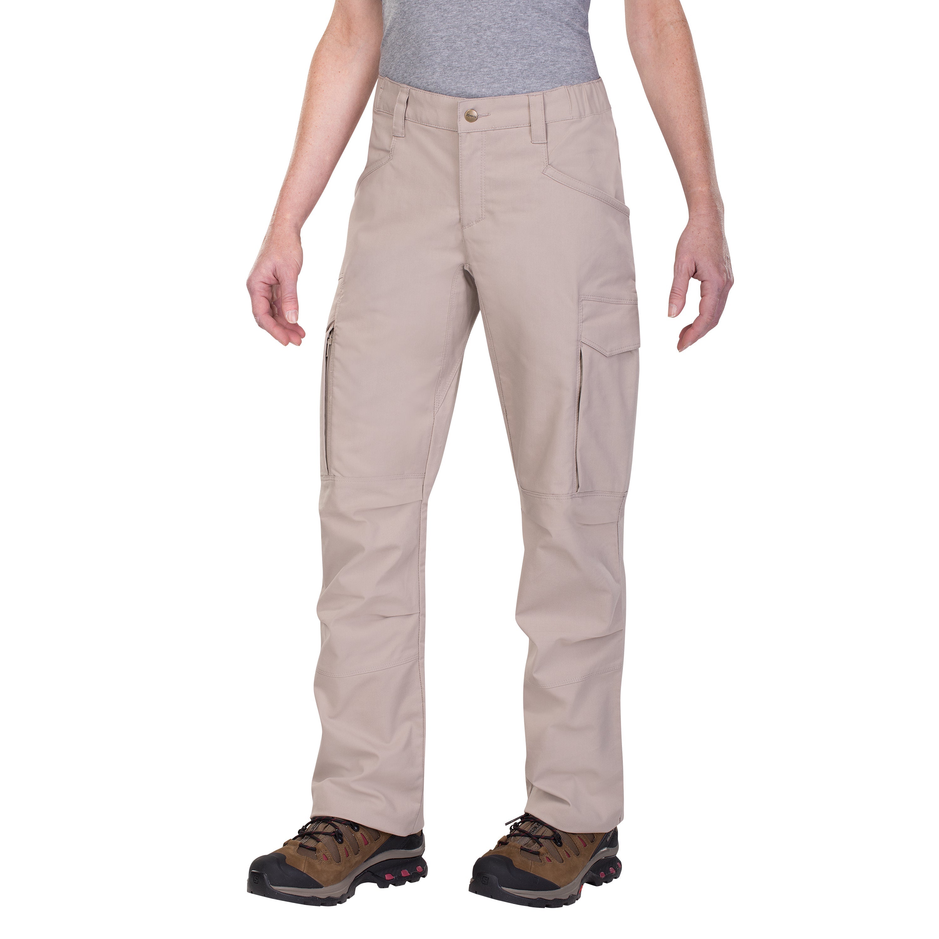 Product shot showing tan women's cargo pants with zippered pockets and brown hiking boots featuring red accents on a white background