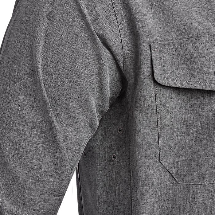 Close-up of a gray heather fabric long sleeve shirt featuring a chest pocket and underarm grommets showcasing a textured weave and subtle dark stitching