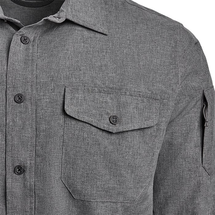 Close-up of a gray long-sleeved shirt featuring a chest pocket, zippered sleeve pocket, and unique button detailing showcasing a textured fabric and subtle heather gray tones