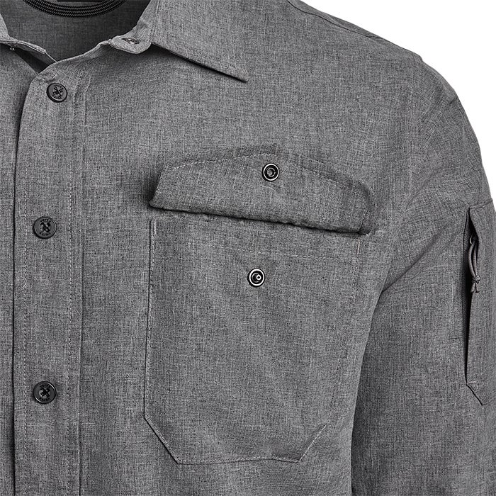 Close-up of a gray long-sleeved shirt featuring a unique flap pocket, dark buttons, and a zippered sleeve pocket showing detailed texture