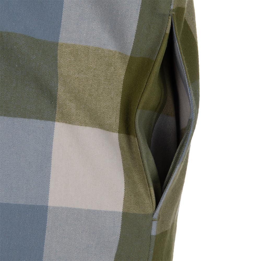 Close-up of a textile detail showing a patch pocket on a garment featuring a blue green and beige plaid pattern with visible stitching