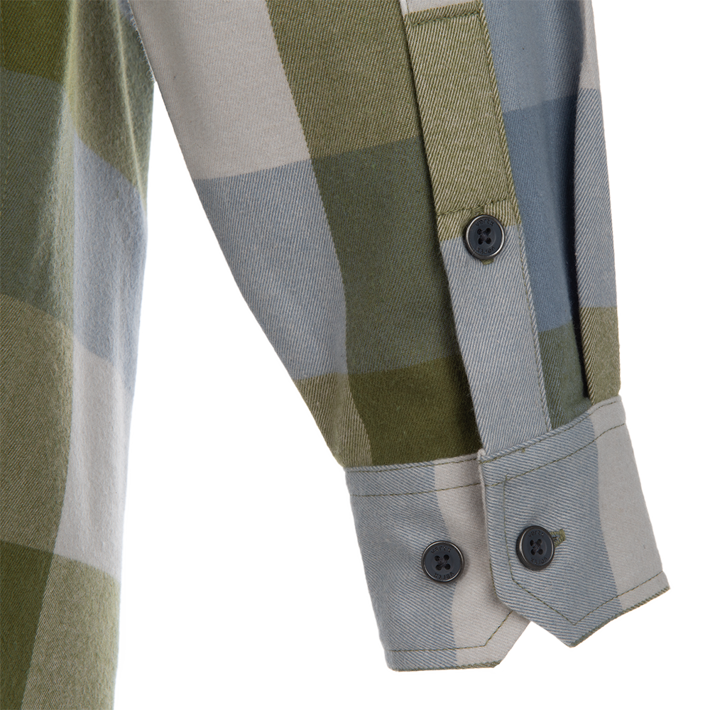 Close-up of a textile's sleeve featuring a green, gray, and beige checkered pattern with dark buttons and mitered cuffs.