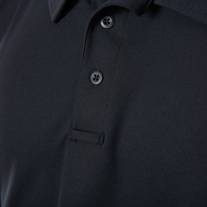 Close-up of a dark-colored polo shirt featuring a small chest pocket, three dark buttons, and a textured fabric.