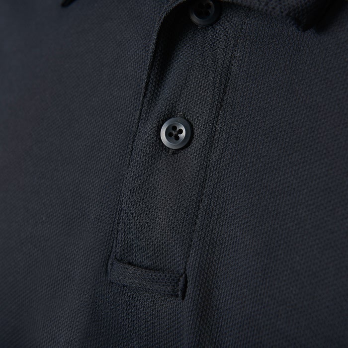 Close-up of a dark-colored polo shirt showcasing its textured fabric, four-button placket and small chest pocket