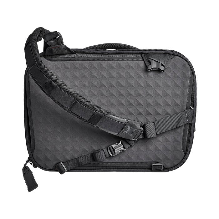 Product shot of a Peak Design Travel Backpack featuring a dark gray geometric textured exterior adjustable padded shoulder straps and a unique zipper pull.