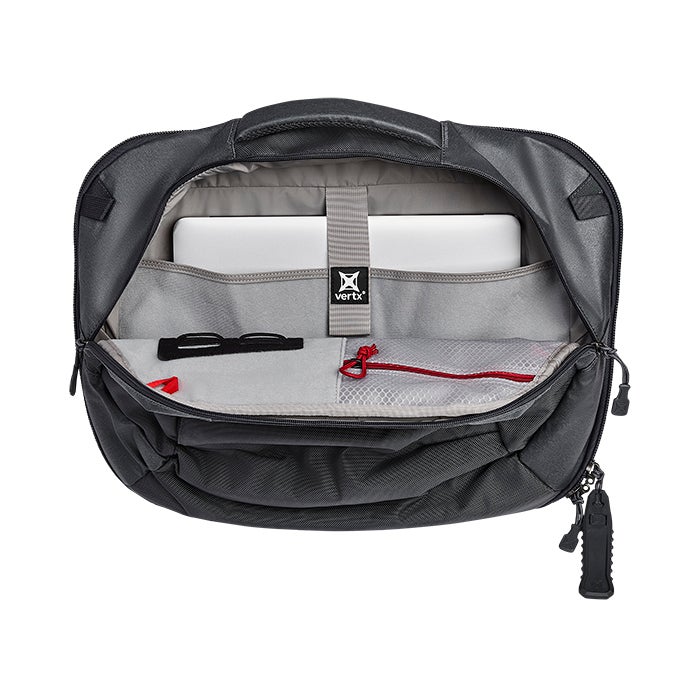 Product shot of a Vertex black laptop bag open showing its interior gray lining, a laptop, glasses, and a red zippered pouch