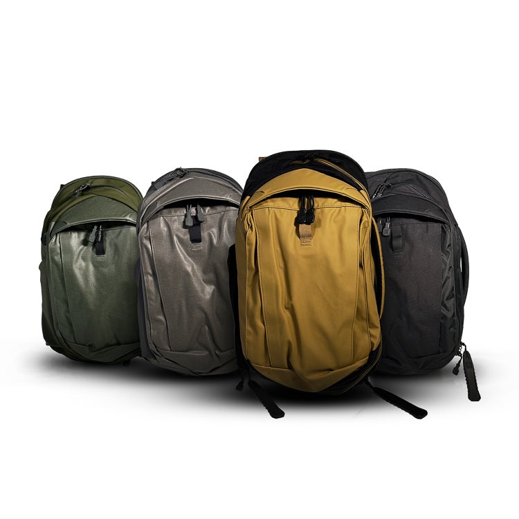 Product photography showing four stylish backpacks in olive green, gray, mustard yellow, and black featuring durable zippers and sleek designs