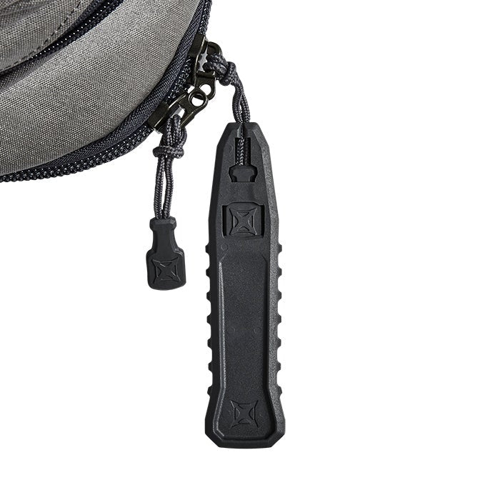 Close-up of a gray bag zipper pull featuring a black plastic zipper pull with textured sides and embossed logos a dark gray nylon zipper and matching small pull tab