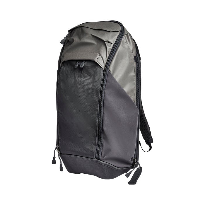 Product shot of a gray and black Peak Design Travel Backpack showing its multiple zipper compartments and durable fabric