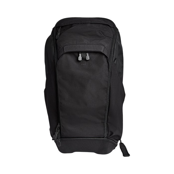 Product shot of a black ballistic nylon backpack featuring dual zippers and a reinforced bottom panel against a white background