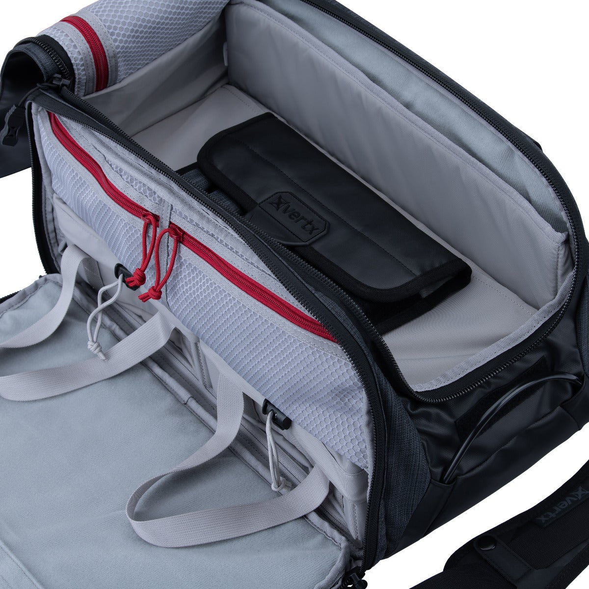 Product shot of a black Xvertx camera bag featuring grey interior compartments red zipper accents and a dedicated smaller pouch