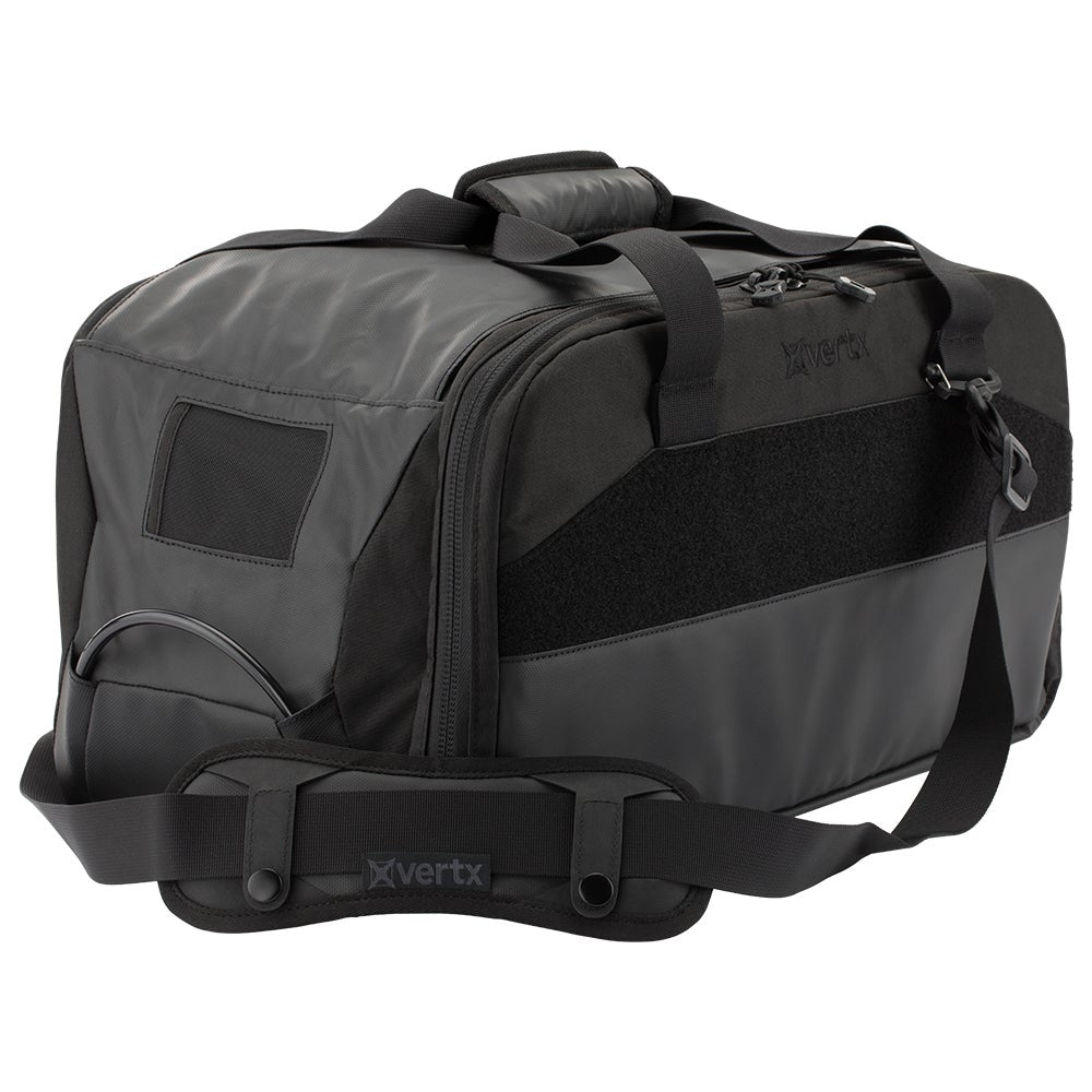 Vertrx black duffel bag featuring a padded shoulder strap MOLLE webbing and a zippered main compartment with multiple pockets